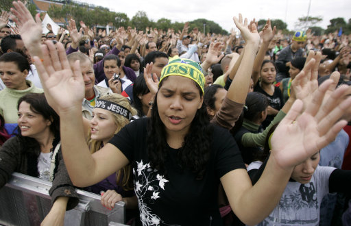 Evangelical protestants pray during the annual March for Jesus in Sao Paulo, Thursday, June 3, 2010. More than one million people attended the event, organizers said. (AP Photo/Nelson Antoine)